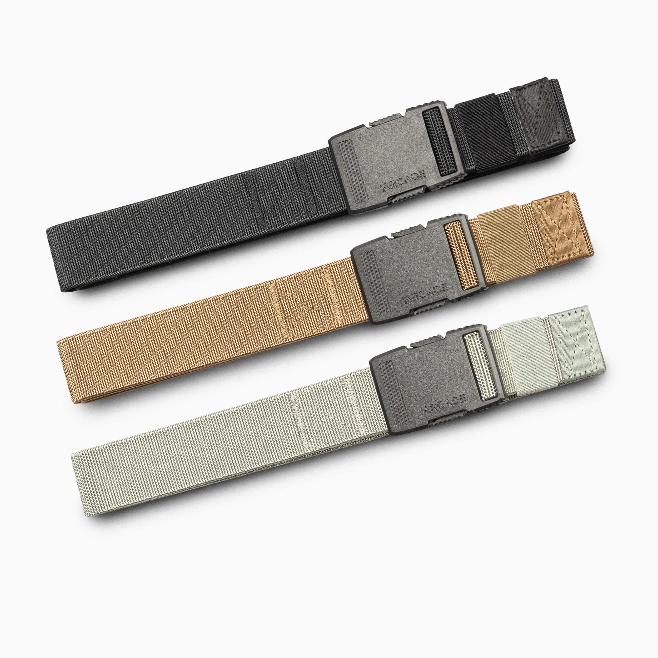 The Arcade Belts Hardware Slim Kit features three versatile belts in black, tan, and light gray, each with a rectangular plastic buckle engraved with “ARCADE,” displayed on a white background.