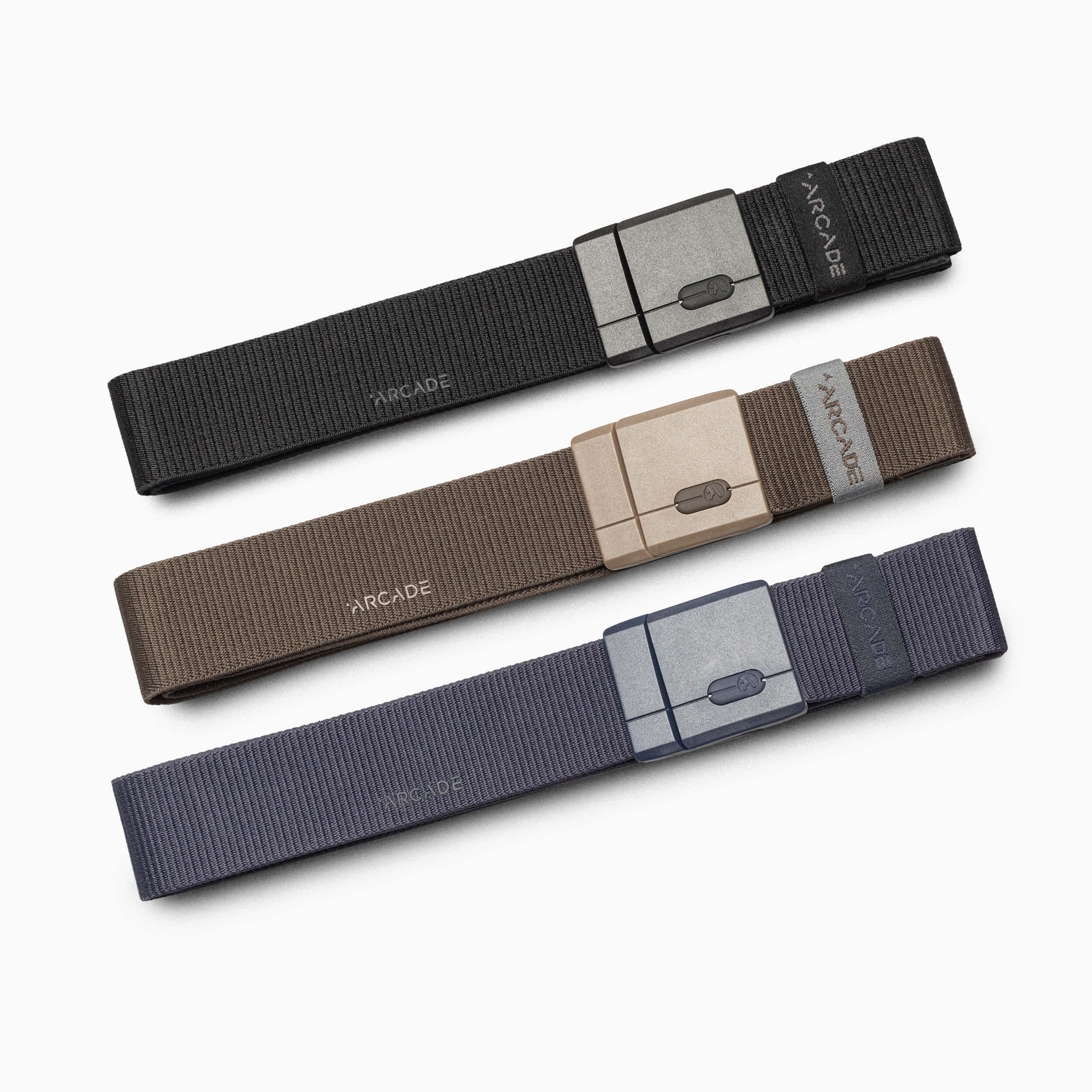 Three Arcade Belts Mag Kit belts in black, brown, and gray with matching SwiftLock stretch buckles, each labeled "ARCADE," are neatly arranged parallel to each other on a white background.
