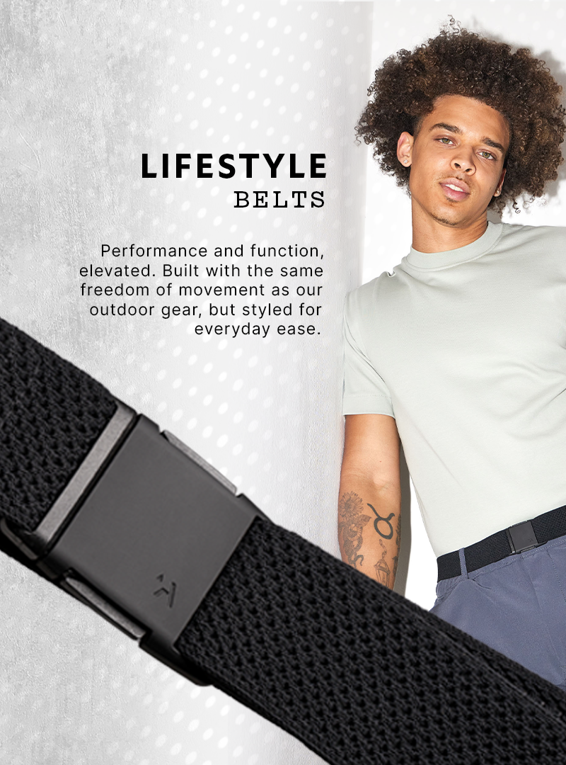 A person in a light gray t-shirt and dark pants models a black Low Profile Belt. Lifestyle Belts—performance and function, elevated. Built with the same stretch webbing as our outdoor gear, but styled for everyday ease.