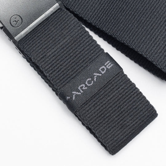 Close-up of a black low profile Belt Loopkeepers from Arcade Belts with a black metal buckle and ARCADE embroidered in white, perfect for travelers who value both style and functionality.