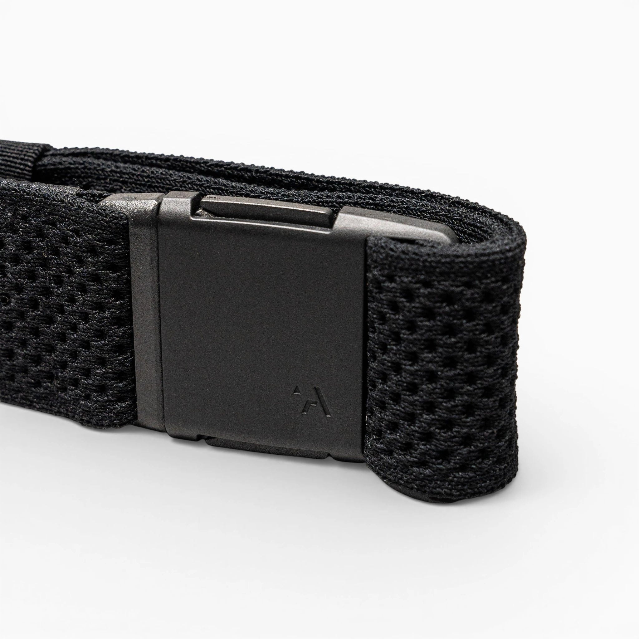 A close-up of the Arcade Belts Momentum strap in black shows its textured, mesh-like webbing and a matte black rectangular buckle with a small logo, all displayed against a light gray background.