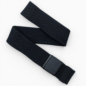 The Arcade Belts Momentum is a black woven fabric belt with a rectangular black buckle, adjustable stretch webbing, and a perforated textured pattern for comfort and style, shown laid out on a white background.
