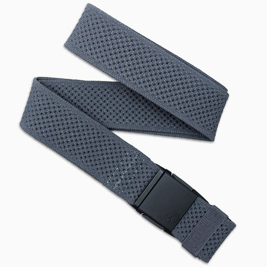 The Arcade Belts Lifestyle Kit is a grey, textured stretch webbing belt with a black rectangular buckle, shown in a loose zigzag on a white background.