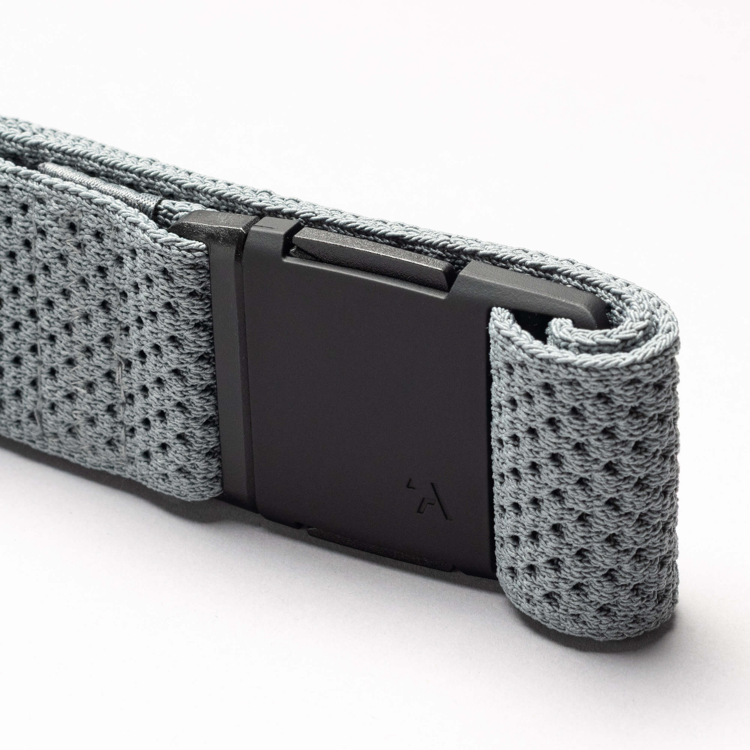 A close-up of the gray Arcade Belts Momentum belt, featuring a black rectangular buckle and textured stretch webbing, is displayed against a plain white background.