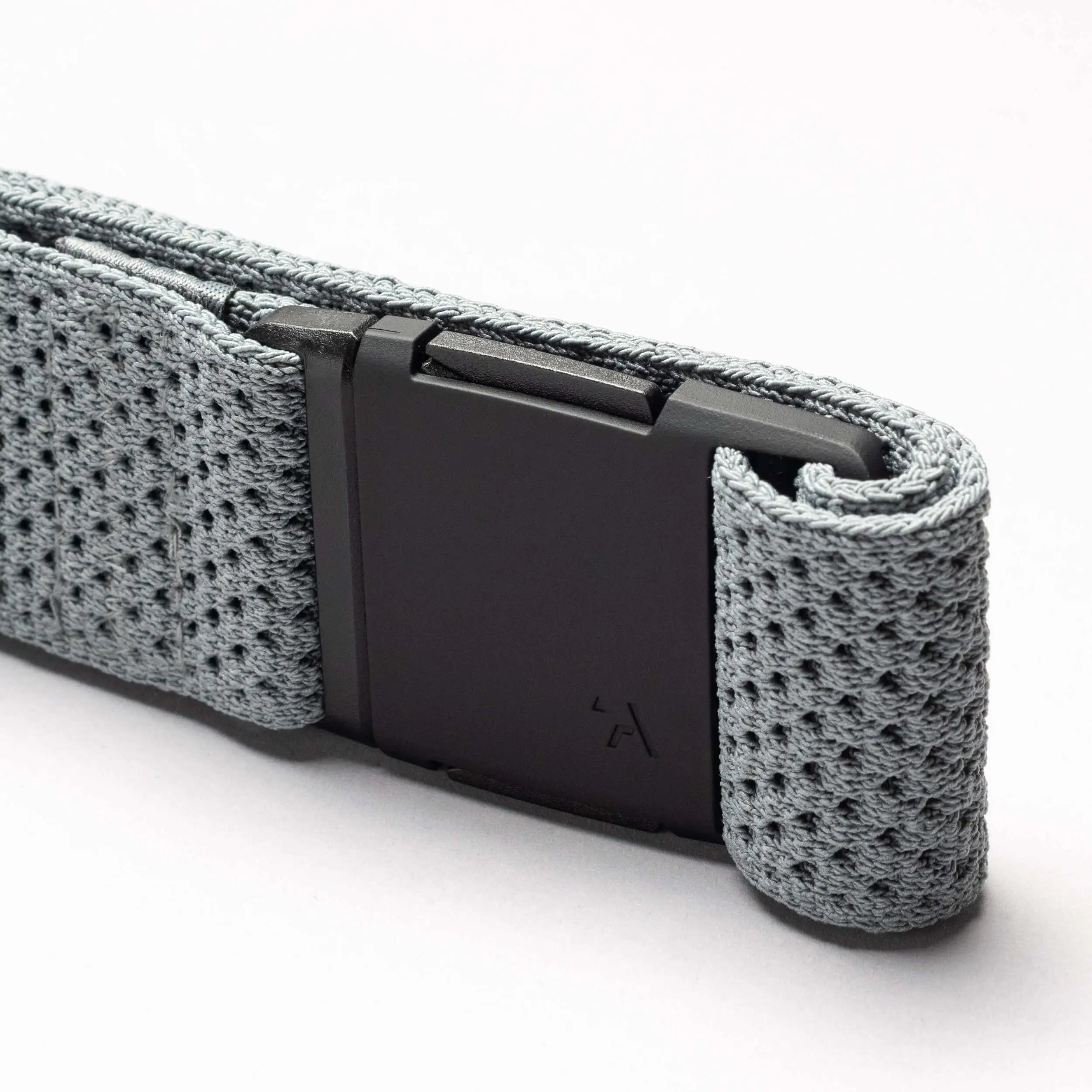 A close-up of the gray Arcade Belts Momentum belt, featuring a black rectangular buckle and textured stretch webbing, is displayed against a plain white background.