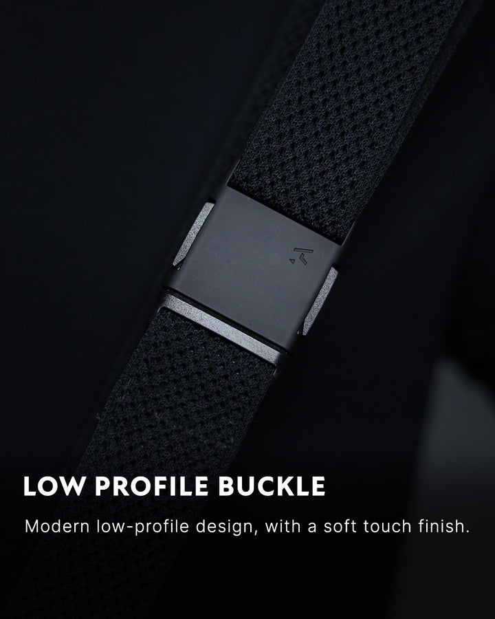 Close-up of a modern, low-profile plastic buckle on a textured Arcade Belts strap, with text describing its soft touch finish and sleek design.