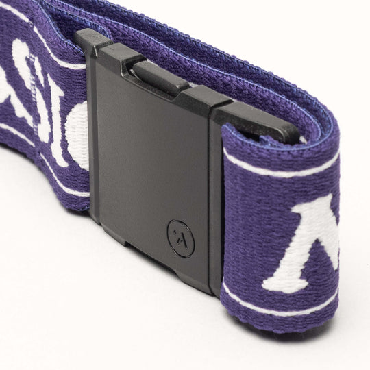 Close-up of the Arcade Belts Mothership Classic: a purple strap with white lettering, black rectangular buckle, and small circular logo. This special edition honors the KT-22 chair lift and supports the High Fives Foundation.