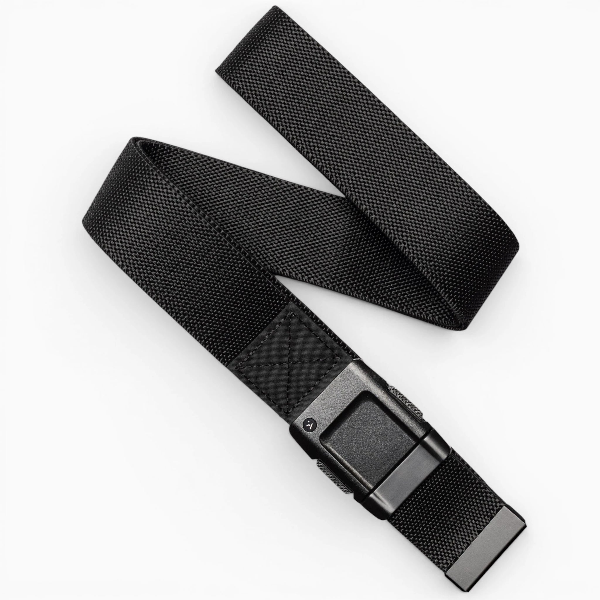 The Arcade Belts Motion is a black woven fabric belt with a rectangular black buckle, pictured loosely coiled on a white background—offering modern style and everyday comfort.