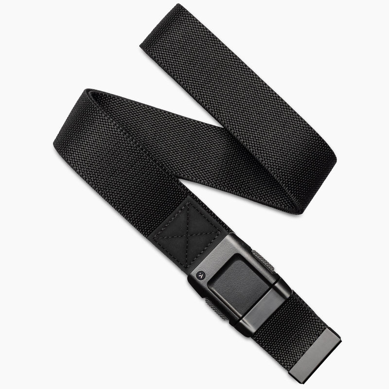 The Arcade Belts Motion is a black stretch webbing belt with a rectangular black buckle, shown diagonally on a white background. Partially coiled, it highlights both the buckle and end for a sleek, modern look.