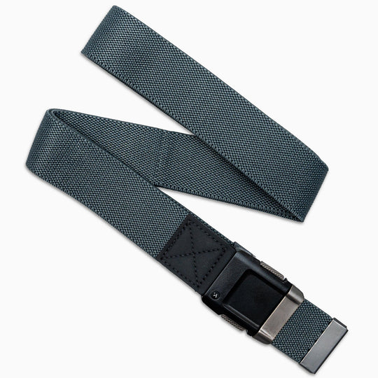 The Arcade Belts Lifestyle Kit features a gray stretch webbing belt with a textured surface, black leather accent by the buckle, and a matte black metal buckle, shown on a white background.