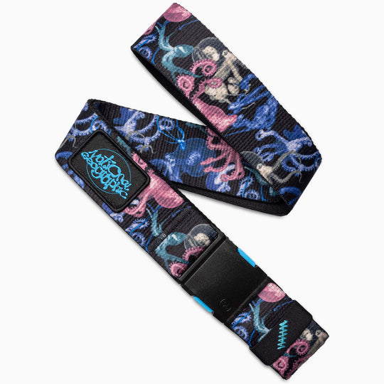 The Arcade Belts National Geographic fabric belt in Secrets Black features a multicolored octopus pattern, a black plastic buckle, and a teal and black embroidered patch, perfect for inspiring adventure.