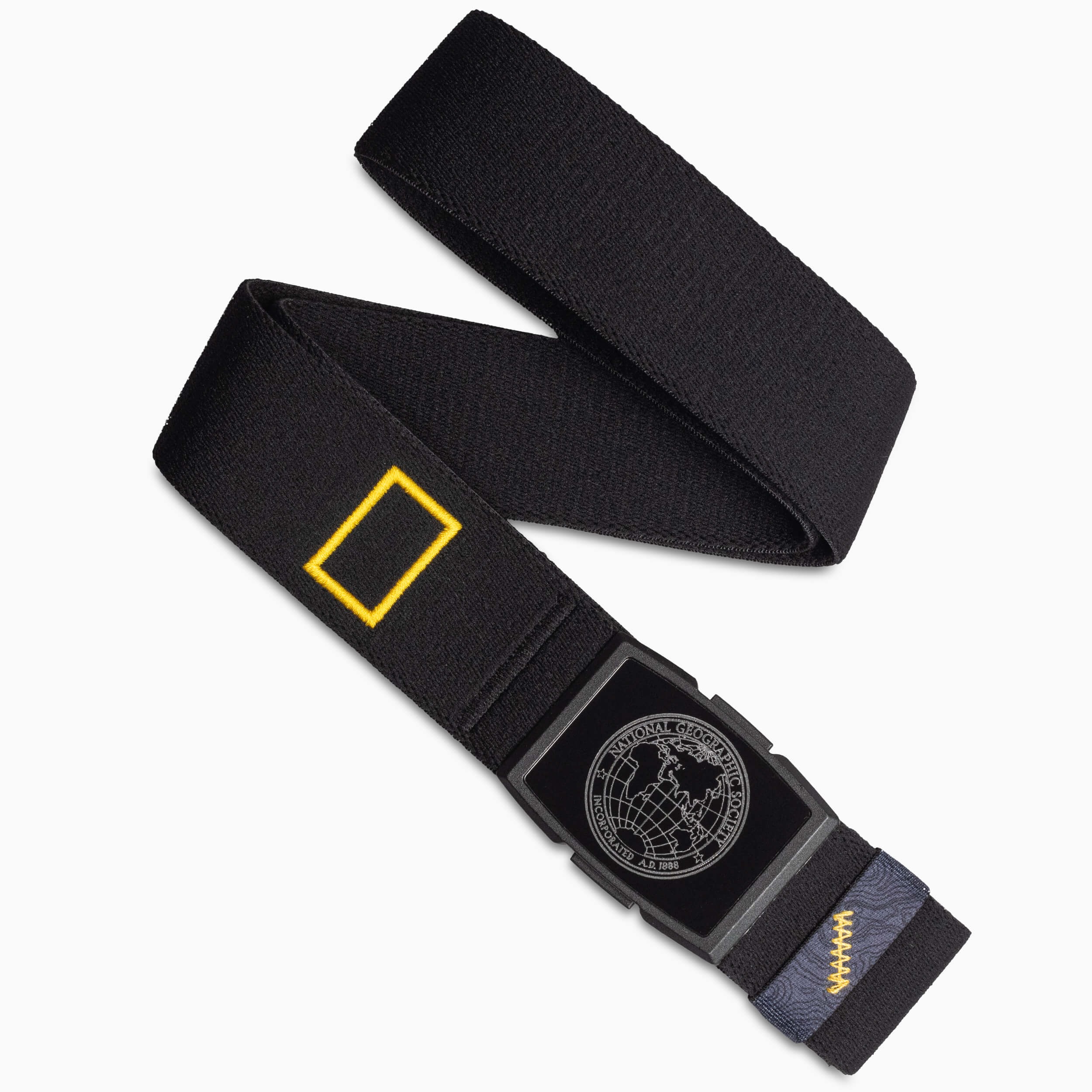 A black elastic stretch belt with a rectangular yellow patch and a black buckle featuring a world map design. The low profile belt also has yellow stitching and a blue patterned detail near the buckle, perfect for travel belts enthusiasts.