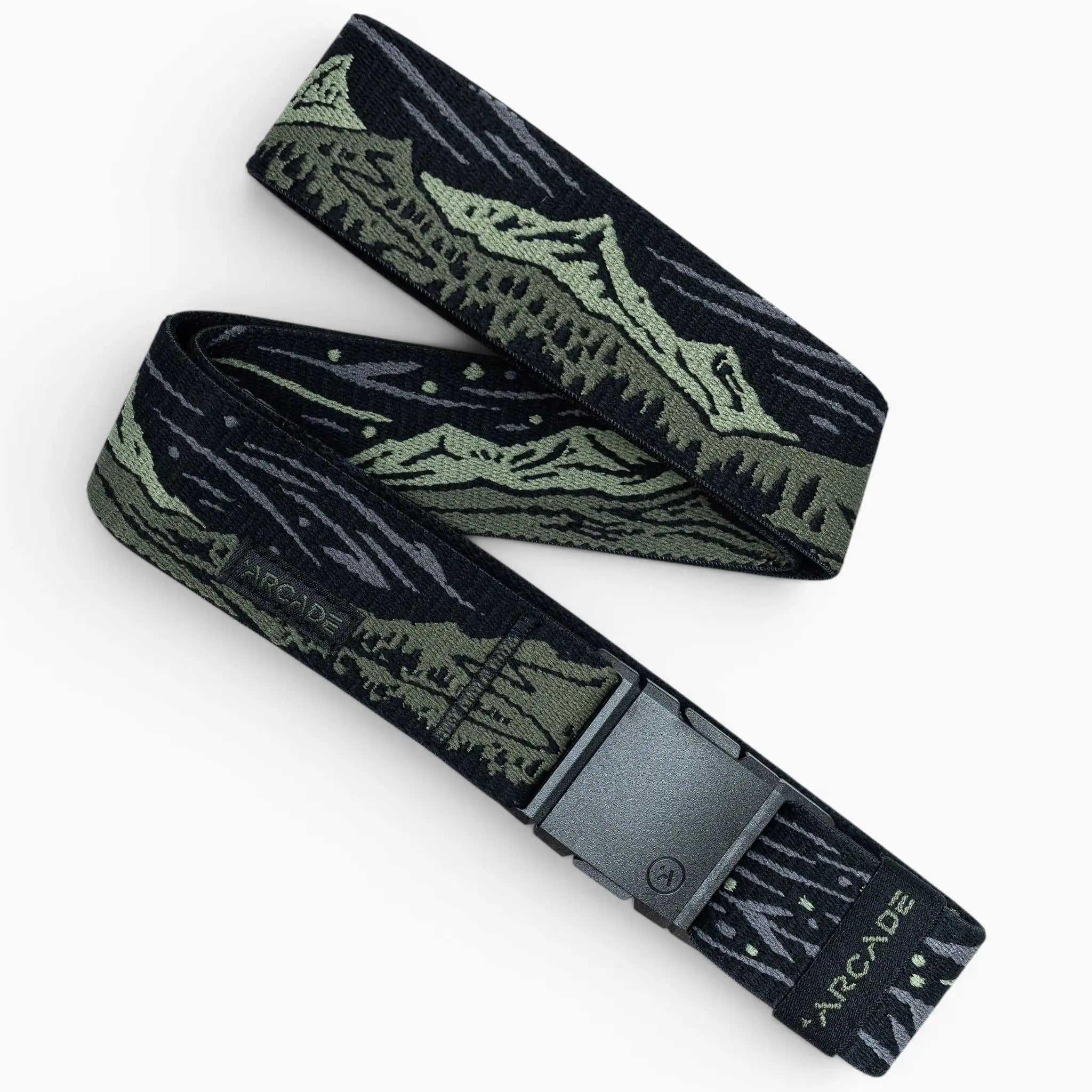 The Out of Range belt by Arcade Belts is black and olive green with a mountain landscape design, a black rectangular buckle, and “ARCADE” printed near the end of the elastic stretch fabric.