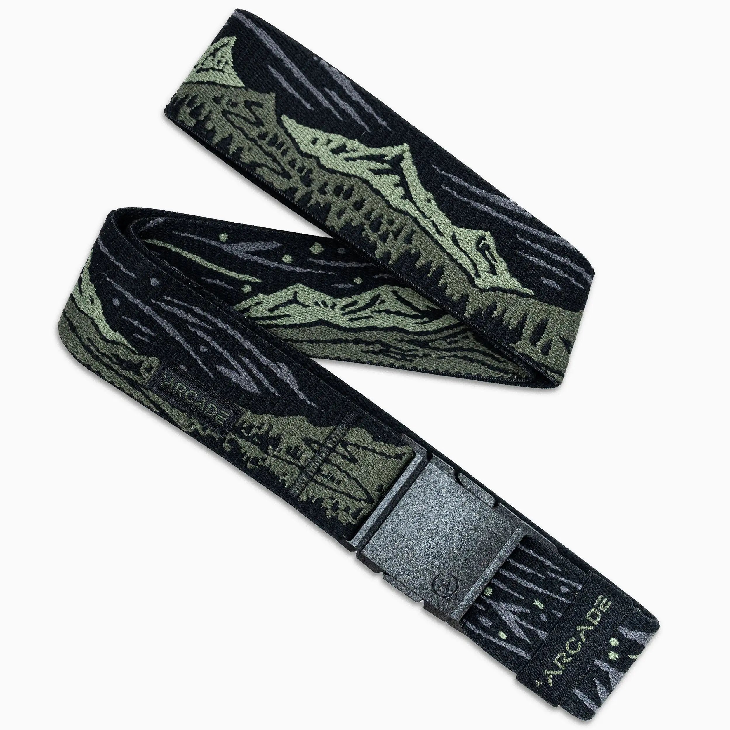 The Out of Range belt by Arcade Belts is black and olive green with a mountain landscape design, a black rectangular buckle, and “ARCADE” printed near the end of the elastic stretch fabric.