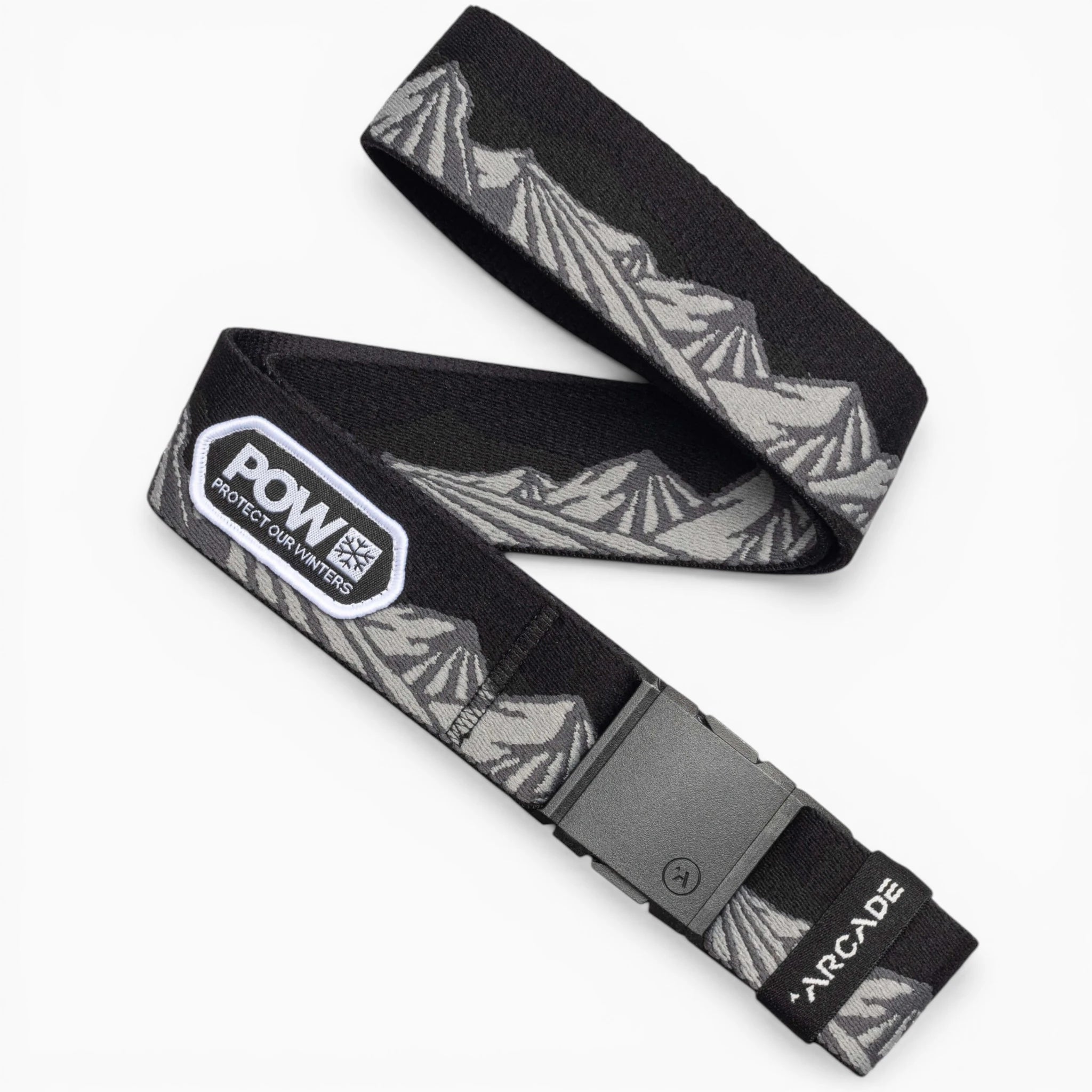 The Arcade Belts POW x Joseph Toney is a black, low-profile belt with a gray mountain design, a POW patch, durable plastic buckle, and white Arcade branding on the tip—perfect for travel belt enthusiasts.