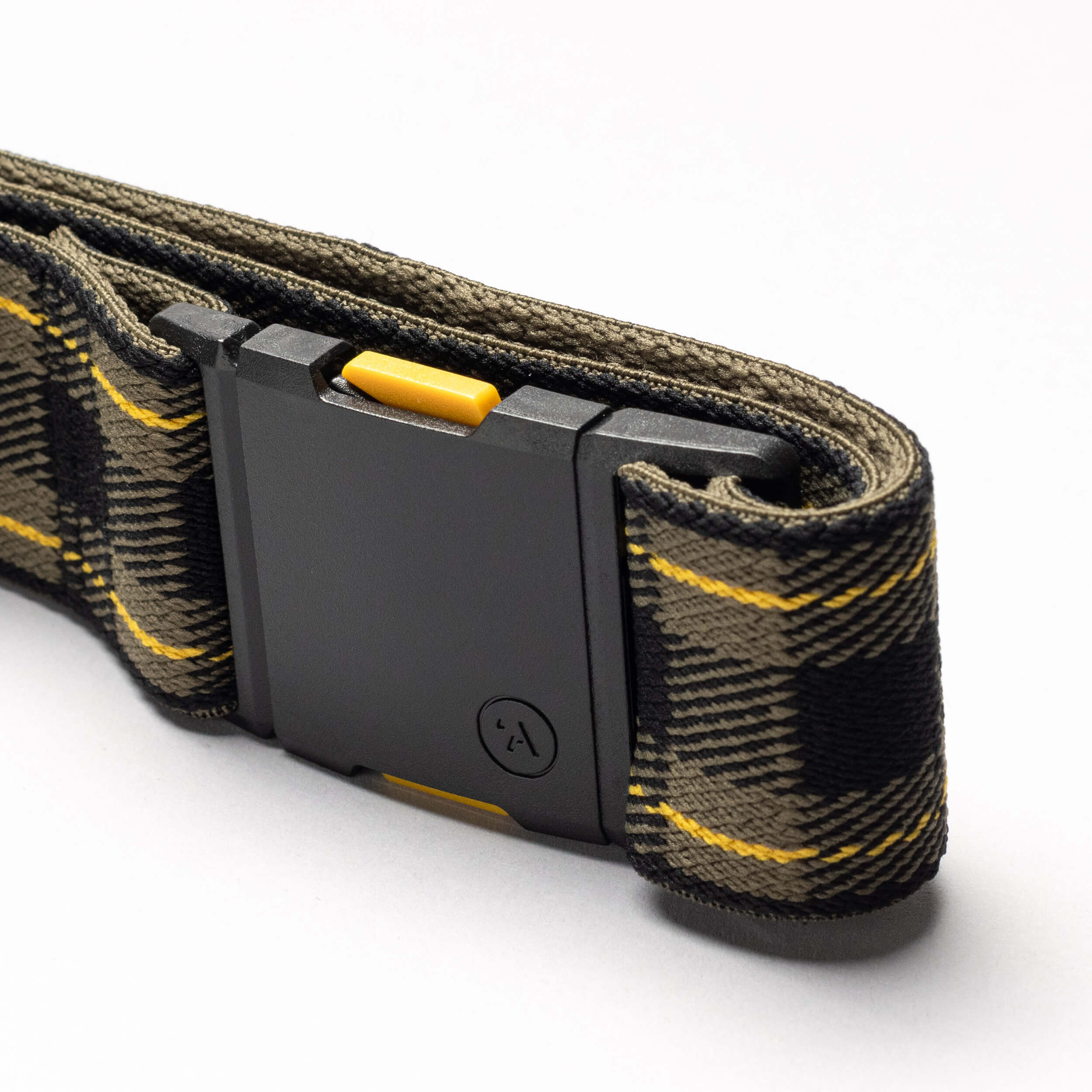 A close-up of Arcade Belts’ Plaid belt, featuring camouflage fabric with yellow accents, a black rectangular buckle, and a yellow button—now available in new limited-time colors.