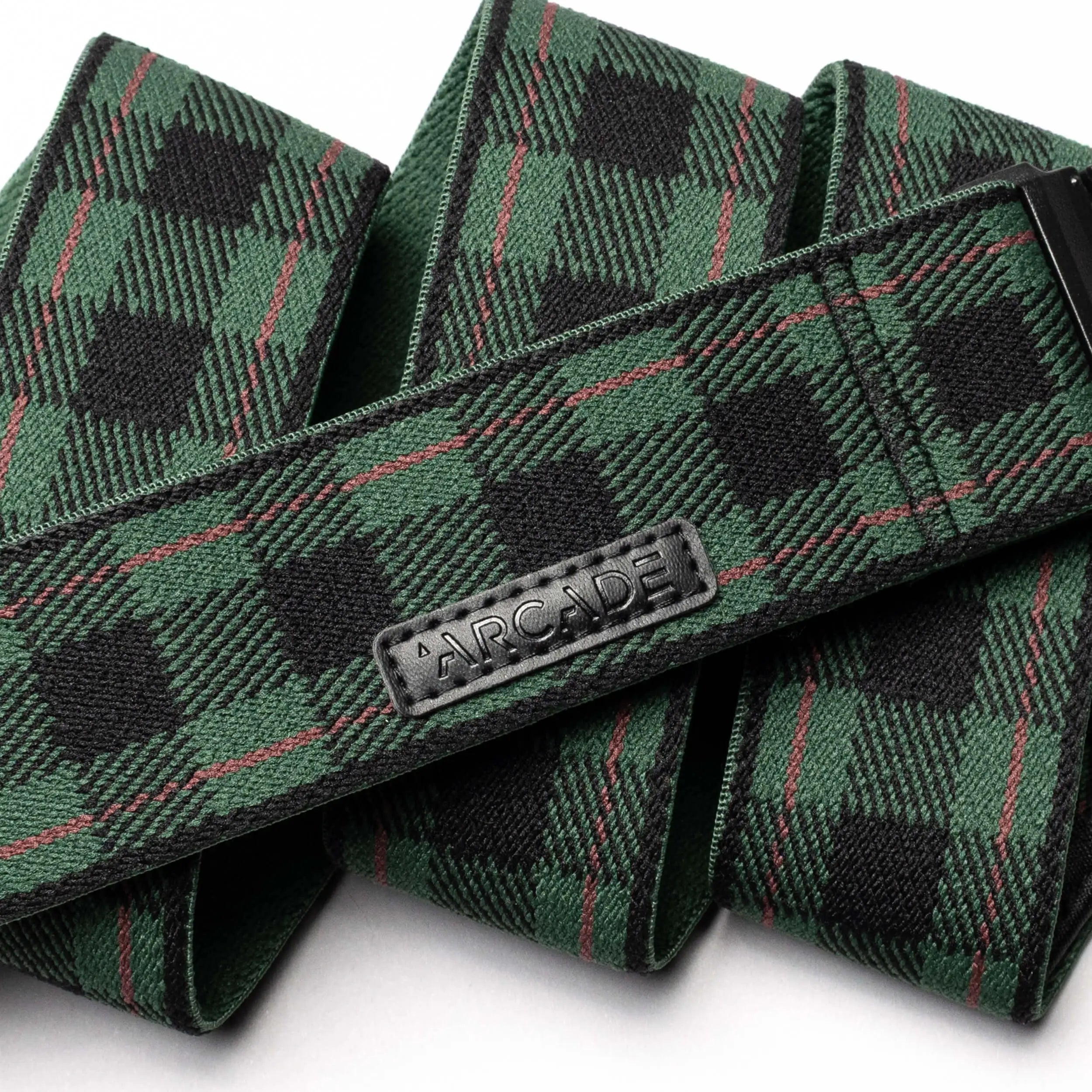 The Arcade Belts Plaid is a green and black stretch webbing belt featuring a low-profile design and a durable plastic buckle.