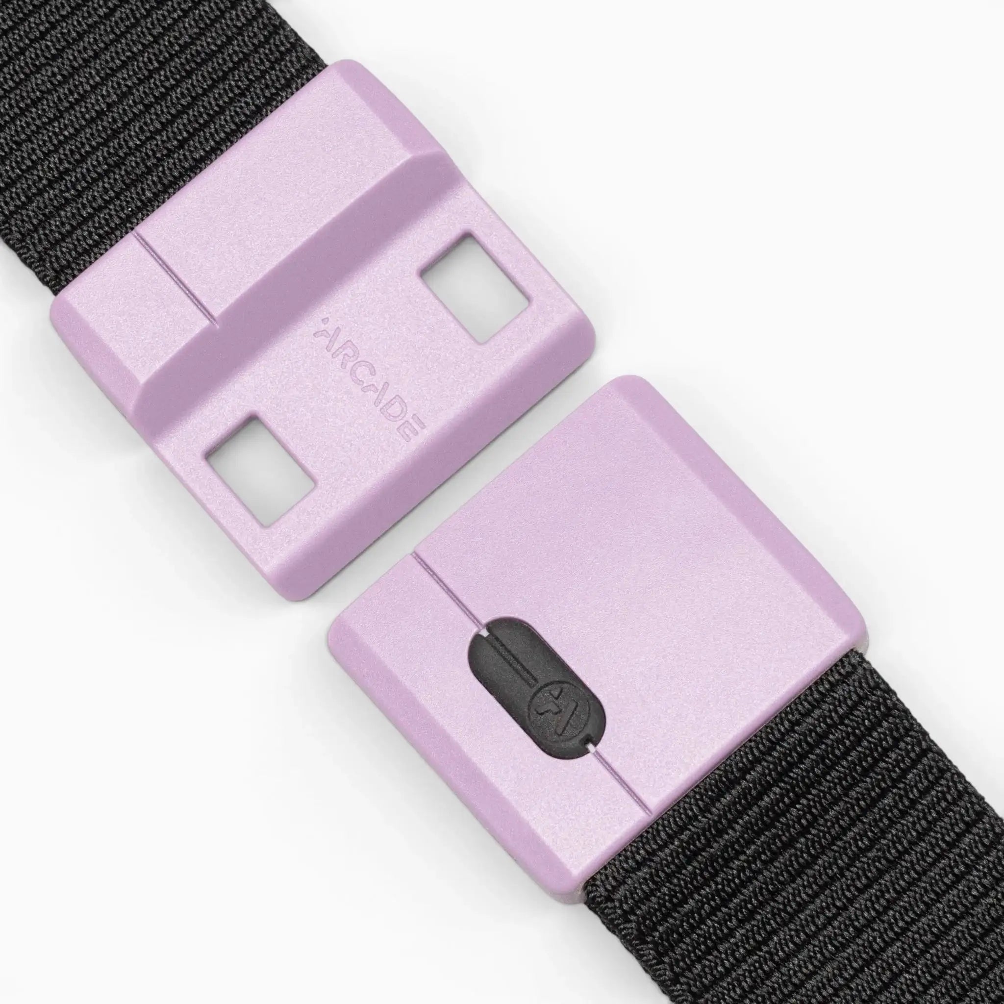 Close-up of the Arcade Belts Polar Mag—a black woven, durable belt featuring a lavender plastic buckle. The rectangular buckle is embossed with "ARCADE" and includes two locking holes, enhanced by SwiftLock technology for added security.
