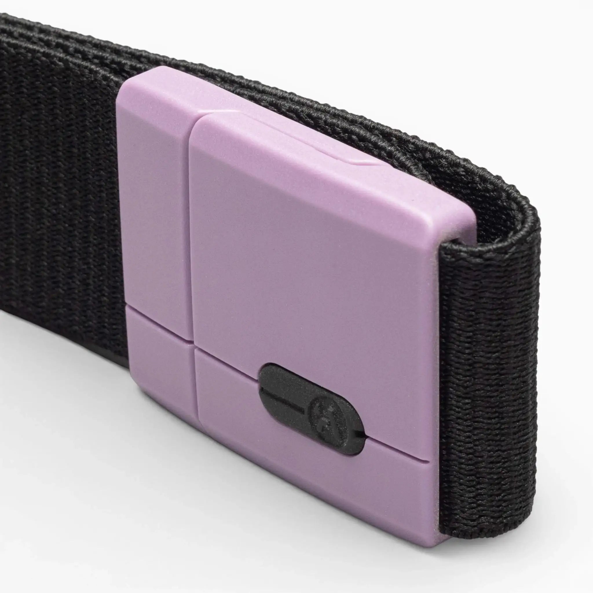 A close-up of the Polar Mag by Arcade Belts—a durable black fabric belt featuring a rectangular, matte lavender buckle with a small black sliding mechanism. The innovative SwiftLock technology provides a secure and effortless magnetic closure, photographed against a plain white background.