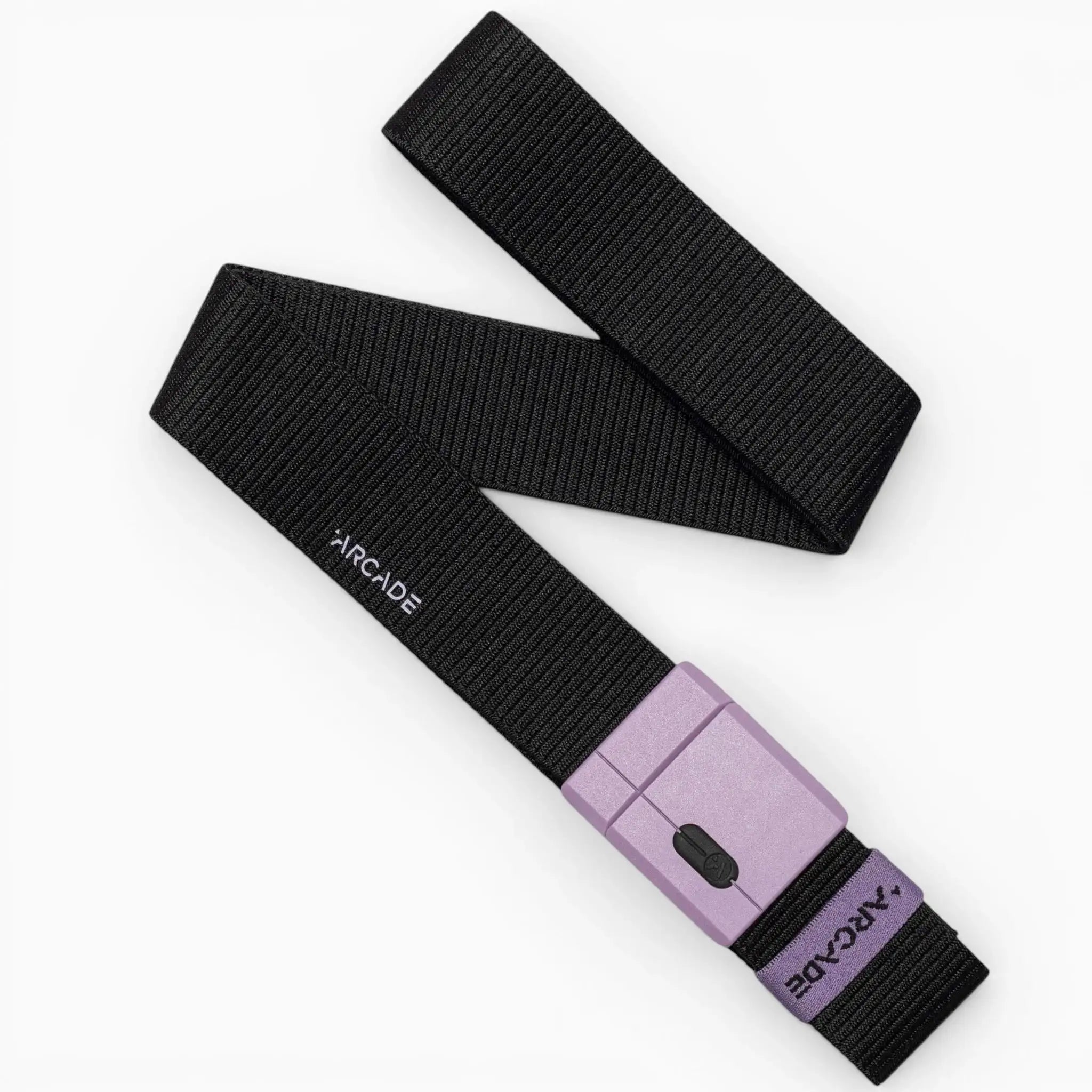 A black fabric belt, the Arcade Belts Polar Mag, is shown laid flat on a white background. The durable belt features “ARCADE” printed in white and has a lavender rectangular buckle displaying the brand name as well.