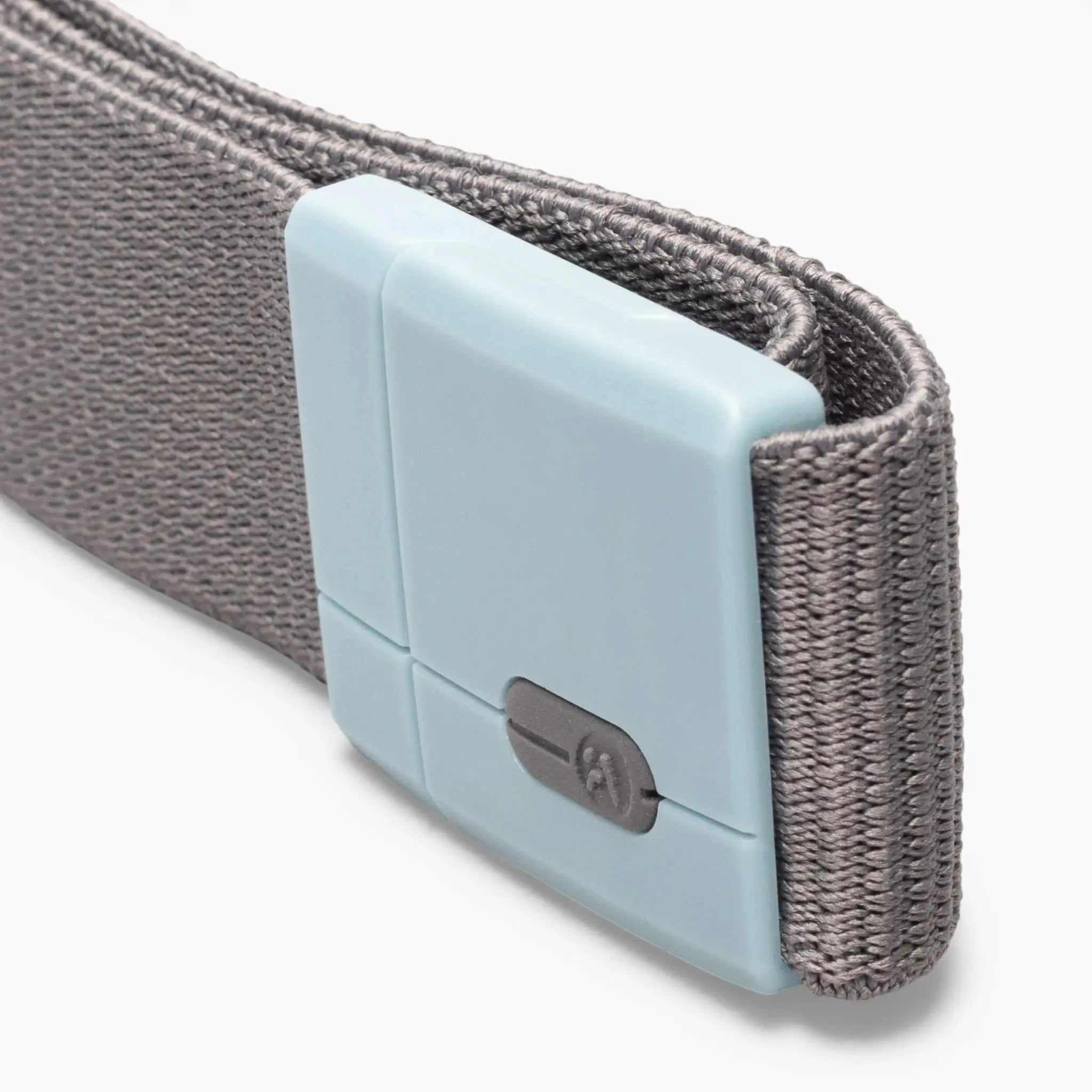 A close-up of the Polar Mag by Arcade Belts shows a gray woven fabric strap paired with a rectangular, light blue plastic buckle featuring SwiftLock technology—a durable design with a small switch for secure and reliable fastening.