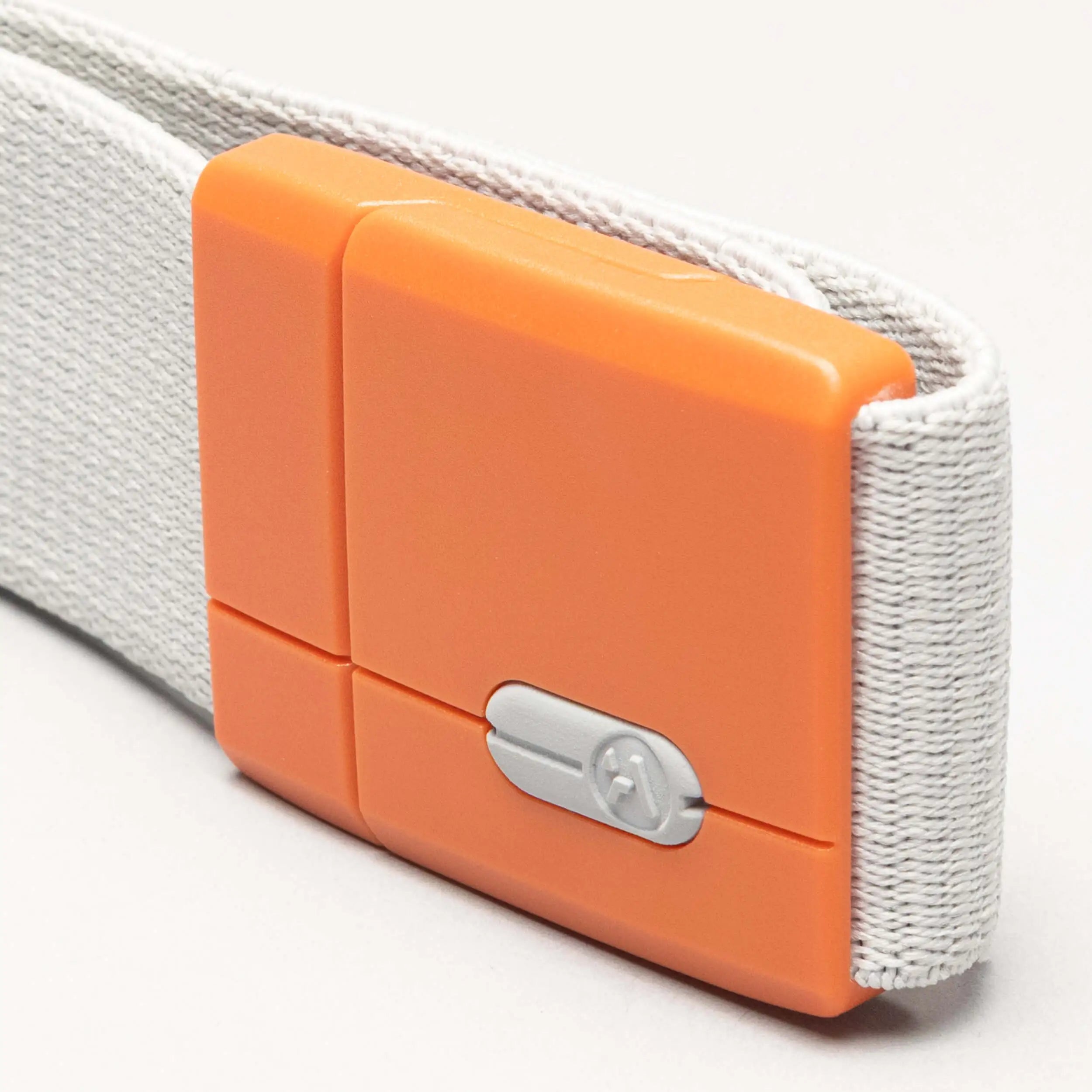 A close-up of the Arcade Belts Polar strap in white fabric, featuring an orange plastic clasp with a small silver screw and a secure tension lock.