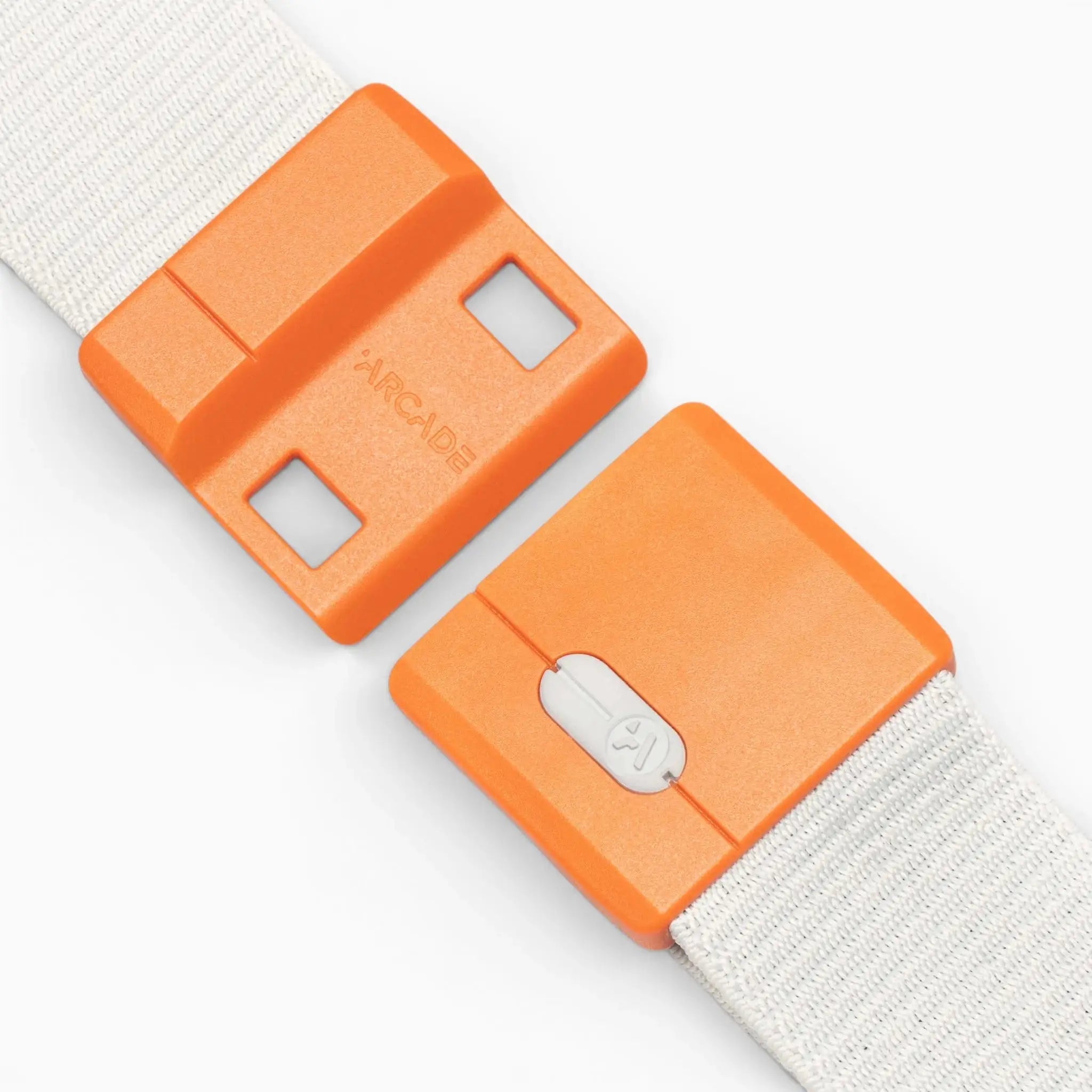 Orange plastic buckle with white strap, one side labeled Polar Mag by Arcade Belts, featuring two square holes and the other with a sliding white clasp, positioned as if about to connect—this durable belt incorporates SwiftLock technology for quick and reliable fastening.
