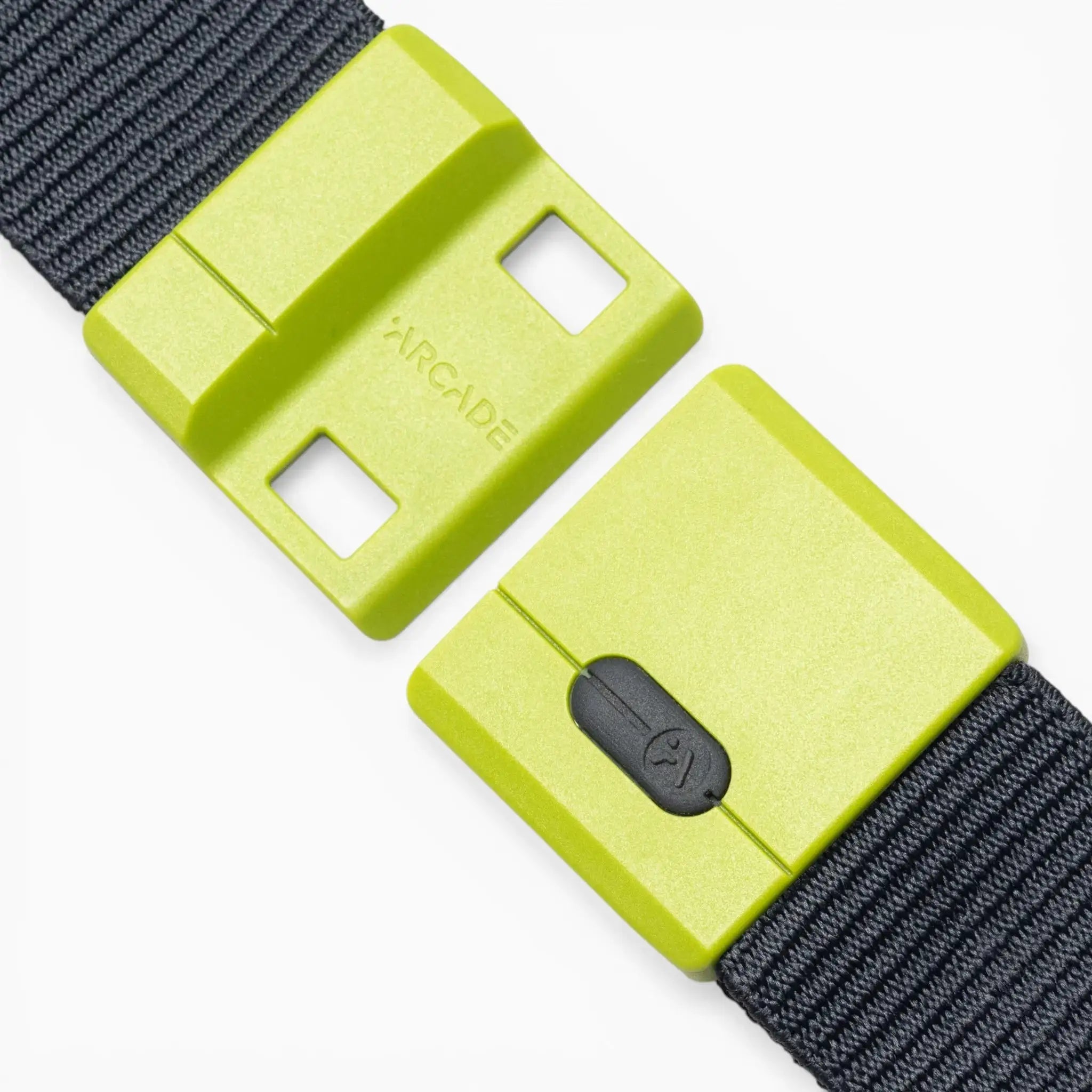 A close-up of the Arcade Belts Polar Mag, featuring a neon green rectangular buckle with black straps. This durable belt displays the word “ARCADE” and includes a small black clasp, enhanced by SwiftLock technology for quick and reliable fastening.