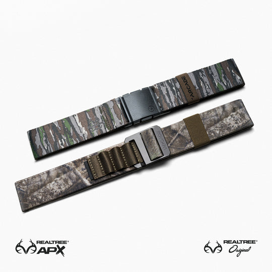 Two camouflage-patterned belts from Arcade Belts Realtree Kit are displayed on a white background. The top belt shows Realtree camo; the bottom features brown and beige camo, making them versatile everyday essentials.