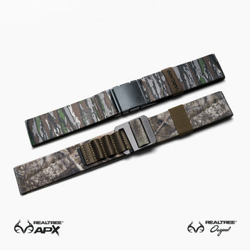 Two camouflage-patterned belts from Arcade Belts Realtree Kit are displayed on a white background. The top belt shows Realtree camo; the bottom features brown and beige camo, making them versatile everyday essentials.