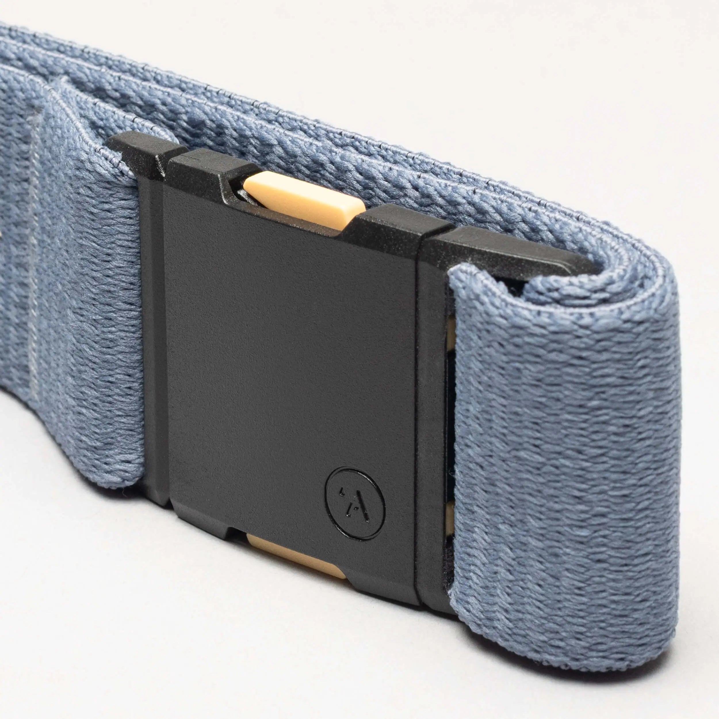 Close-up of the Arcade Belts Save the Waves belt, featuring a blue strap and black rectangular buckle with a yellow accent and small circular logo—ideal for conservation supporters.