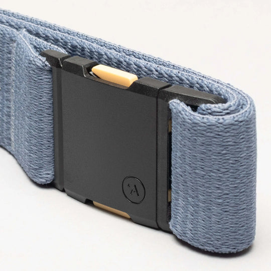 Close-up of the Arcade Belts Save the Waves belt, featuring a blue strap and black rectangular buckle with a yellow accent and small circular logo—ideal for conservation supporters.