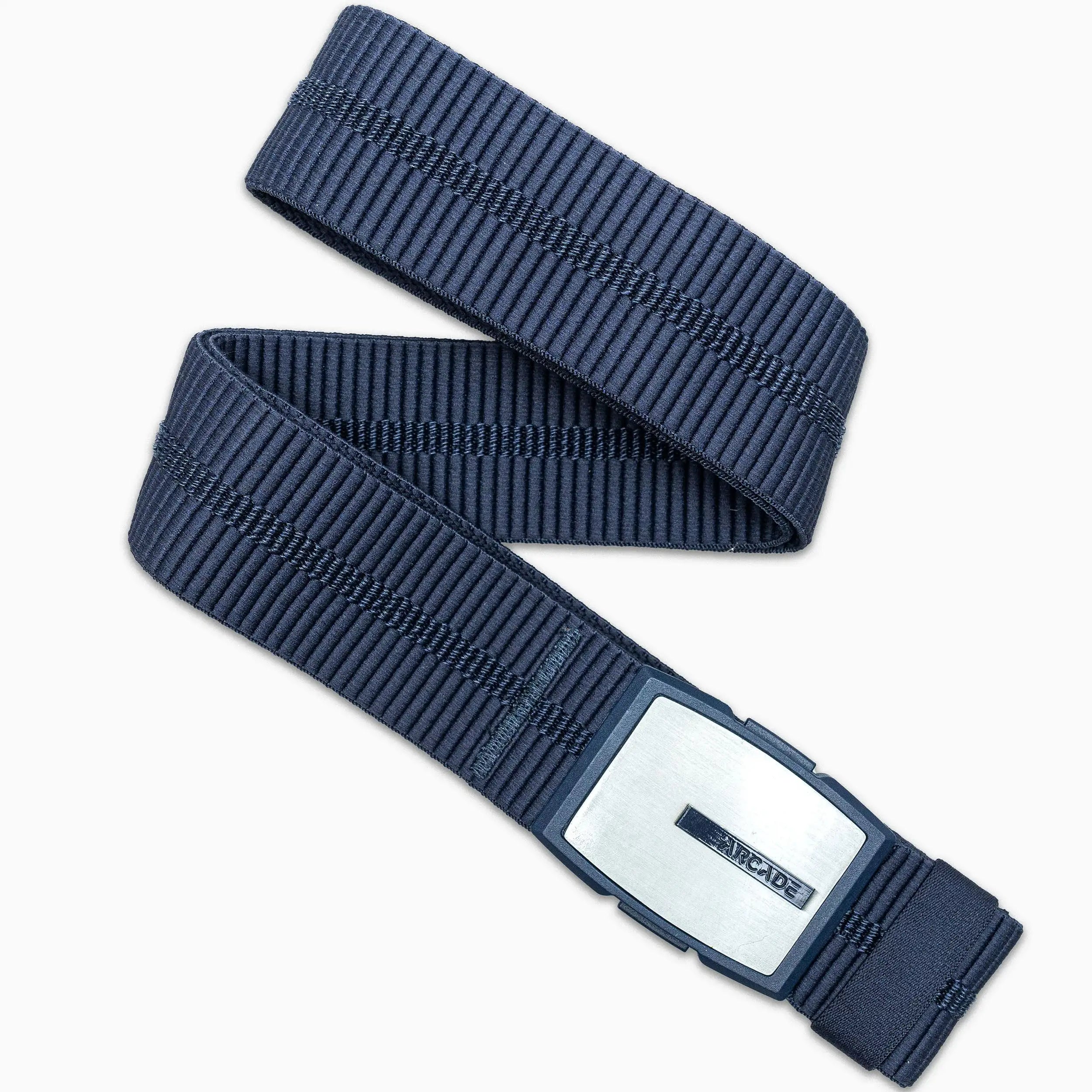 The Arcade Belts Stamped, a dark blue ribbed low-profile belt with a rectangular silver buckle, is arranged in a zigzag pattern on a white background.