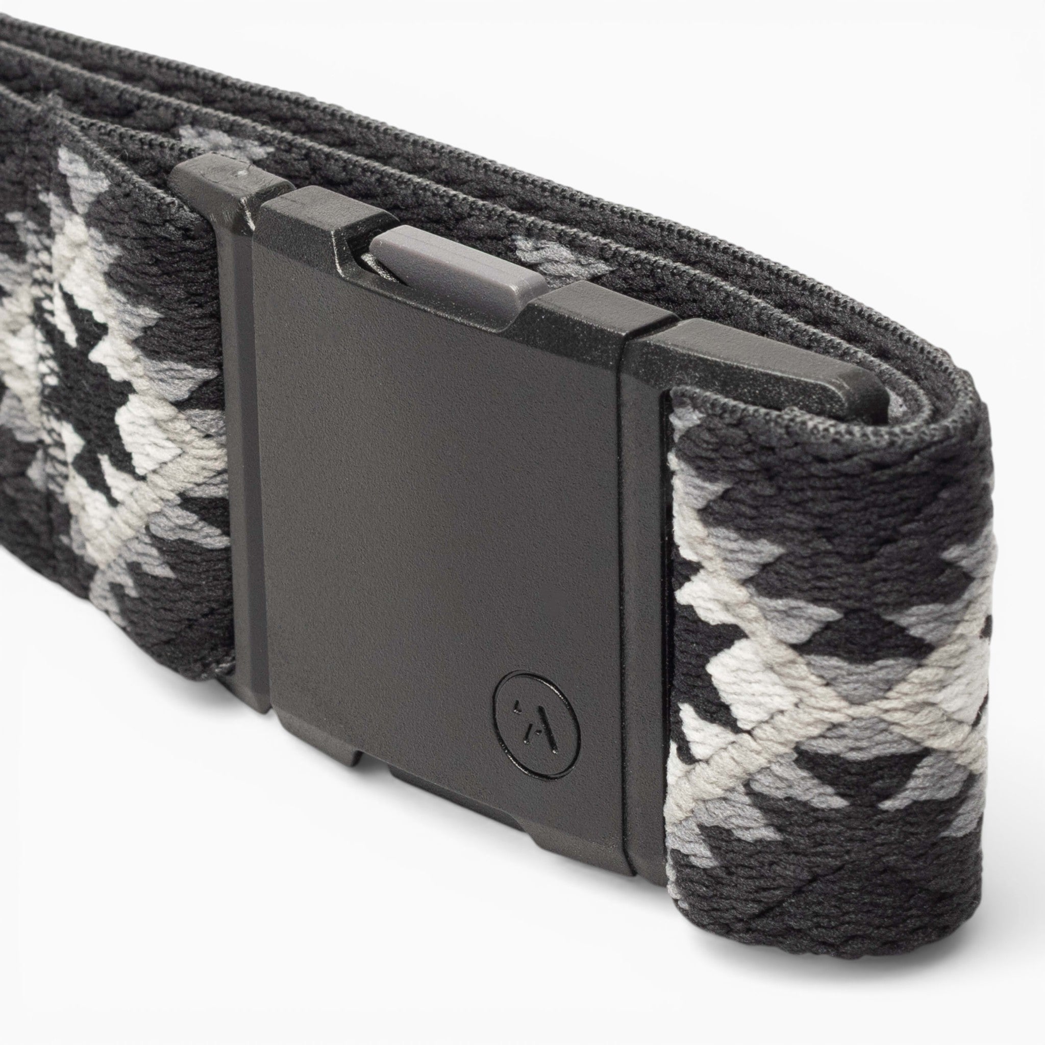 A close-up of the Arcade Belts Vernan Kee fabric belt, featuring geometric black, white, and gray patterns inspired by Navajo rug designs and finished with a rectangular black buckle.