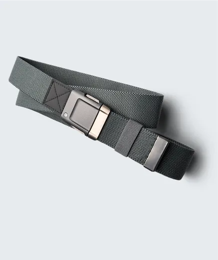 A gray fabric belt with a rectangular metallic buckle and two matching metal loops, displayed coiled on a light gray background.