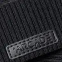 Close-up of black ribbed fabric with a rectangular stitched patch embossed with WOODY, inspired by Arcade Belts’ modern stretch webbing design.